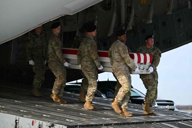 A US Army carry team moves the transfer case containing the remains of US Army Sgt. Edgar Torres Tovar, during the dignified transfer of the remains of two Iowa National Guard members killed in an attack in Syria during a ceremony at Dover Air Force Base in Delaware on December 17, 2025. (Photo by ANDREW CABALLERO-REYNOLDS / AFP)