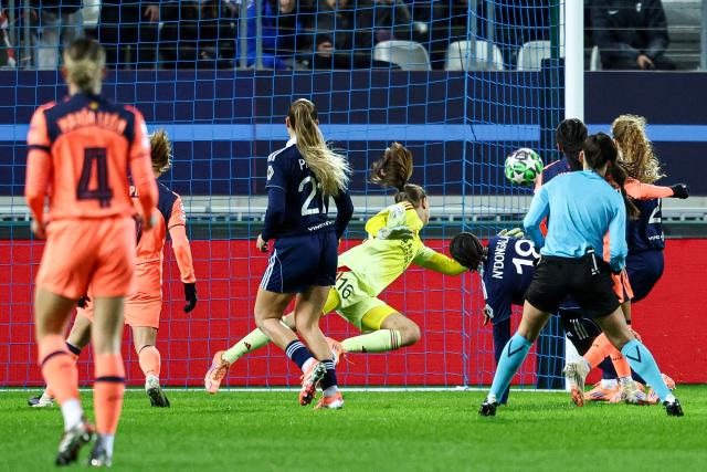 Paris FC's French goalkeeper #16 Mylene Chavas (C) concedes a goal during the UEFA Women's Champions League group-stage football match between Paris FC and FC Barcelona at the Stade Jean-Bouin, in Paris, on december 17, 2025. (Photo by FRANCK FIFE / AFP)