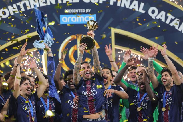 PSG's players celebrate on the podium after winning the 2025 FIFA Intercontinental Cup final football match between Paris Saint-Germain (PSG) and CR Flamengo at the Ahmad bin Ali Stadium in Al-Rayyan on the outskirts of Doha on December 17, 2025. (Photo by Karim JAAFAR / AFP)