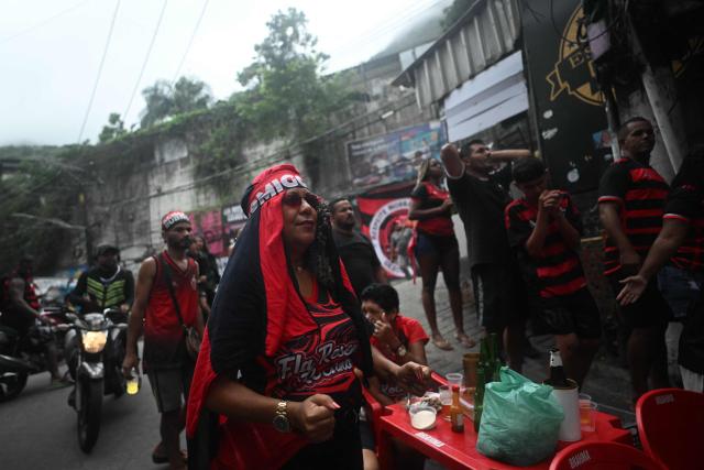 A Flamengo supporter reacts while watching the final match of the 2025 FIFA Intercontinental Cup between Paris Saint-Germain and Flamengo at Rocinha favela in Rio de Janeiro, Brazil on December 17, 2025. (Photo by MAURO PIMENTEL / AFP)