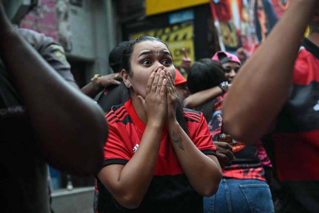 A Flamengo supporter reacts while watching the final match of the 2025 FIFA Intercontinental Cup between Paris Saint-Germain and Flamengo at Rocinha favela in Rio de Janeiro, Brazil on December 17, 2025. (Photo by MAURO PIMENTEL / AFP)