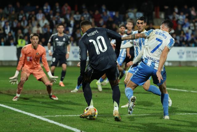 Real Madrid's French forward #10 Kylian Mbappe (back) controls the ball before Talavera's own goal during the Spanish Copa del Rey (King's Cup) round of 32 second leg football match between Talavera CF and Real Madrid CF at El Prado Municipal Stadium in Talavera de la Reina on December 17, 2025. (Photo by Thomas COEX / AFP)