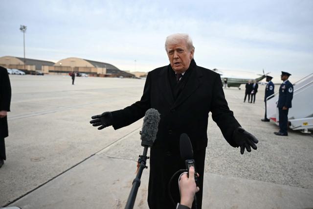 US President Donald Trump speaks to reporters after stepping off Air Force One at Joint Base Andrews on December 17, 2025 upon return from Dover Air Force Base in Delaware where he attended a ceremony for the return of the remains of two Iowa National Guard members and a translator killed in an attack in Syria. (Photo by ANDREW CABALLERO-REYNOLDS / AFP)