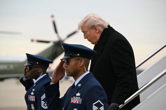 US President Donald Trump steps off Air Force One at Joint Base Andrews on December 17, 2025 upon return from Dover Air Force Base in Delaware where he attended a ceremony for the return of the remains of two Iowa National Guard members and a translator killed in an attack in Syria. (Photo by ANDREW CABALLERO-REYNOLDS / AFP)