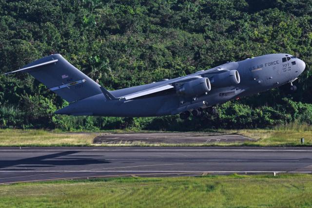 A US Air Force Boeing C-17 Globemaster takes off from José Aponte de la Torre Airport, formerly Roosevelt Roads Naval Station, on December 17, 2025 in Ceiba, Puerto Rico. Aircraft movements and coordinated exercises were observed throughout the day as part of heightened regional military readiness linked to ongoing operations at US military bases and maritime security efforts in the Caribbean. President Donald Trump administration is conducting a military campaign in the Caribbean and eastern Pacific, deploying naval and air forces for what it calls an anti-drugs offensive. (Photo by Miguel J. Rodriguez Carrillo / AFP)
