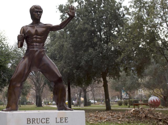 This photograph shows a restored statue honoring late martial arts legend Bruce Lee after returning to it's original location more than a year after it was stolen, in southern Bosnian city of Mostar, on December 17, 2025. The life-size bronze statue of the kung-fu cinema icon was originally unveiled in a park in Mostar in 2005 and has been vandalized several times since. Lee was chosen as a hero that all ethnic groups could relate to in a town that remains deeply divided after fierce fighting between Bosnian Croats and Bosnian Muslims during the country's 1992-95 war. (Photo by AFP)