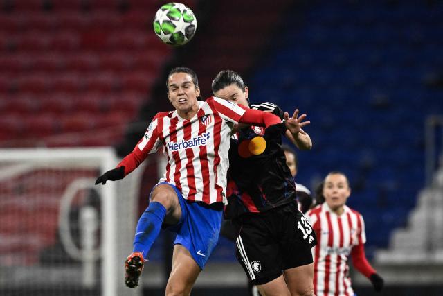Atletico Madrid's Brazilian midfielder #10 Ana Vitoria (L) and Lyon's Dutch midfielder #13 Damaris Egurrola (C) fight for the ball in the air during the UEFA Champions League group-stage football match between Olympique Lyonnais (OL) and Atlético Madrid at the Groupama Stadium in Decines-Charpieu, central-eastern France, on December 17, 2025. (Photo by JEFF PACHOUD / AFP)