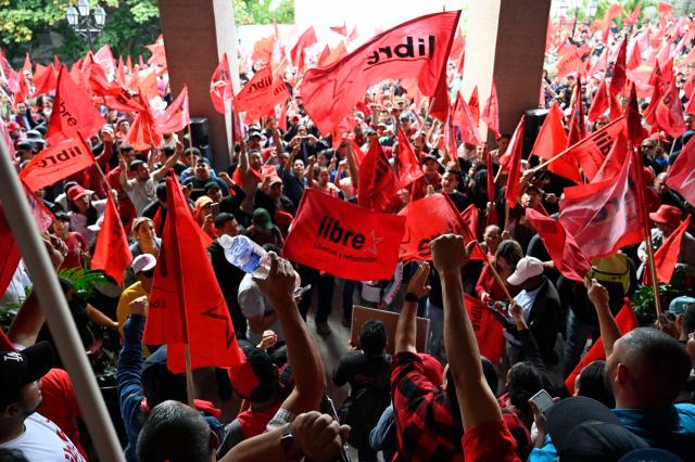 Supporters of the ruling Libertad y Refundacion (LIBRE) party gather in front of the Presidential House in support of Honduran President Xiomara Castro and against electoral fraud in Tegucigalpa on December 17, 2025. (Photo by Orlando SIERRA / AFP)