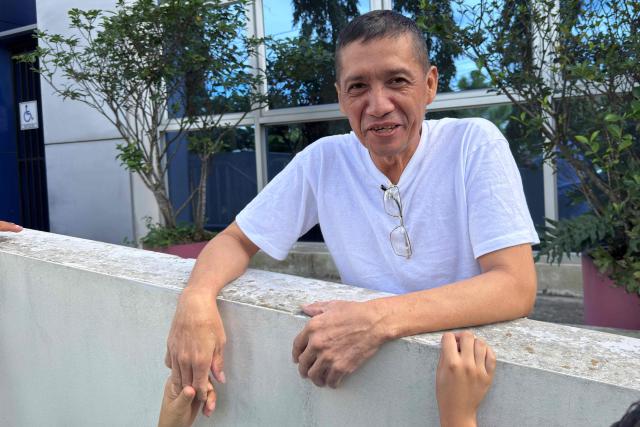 Salvadorian local leader Jose Angel Perez smiles after a hearing at the Integrated Judicial Center of Santa Tecla, El Salvador on December 17, 2025. El Salvador's judiciary sentenced Salvadorian environmental lawyer Alejandro Henriquez and local leader Jose Angel Perez to three years in prison for "aggressive resistance" and "public disorder", but granted them conditional release, according to the ruling issued on December 17, 2025. (Photo by Rudy QUIROZ / AFP)
