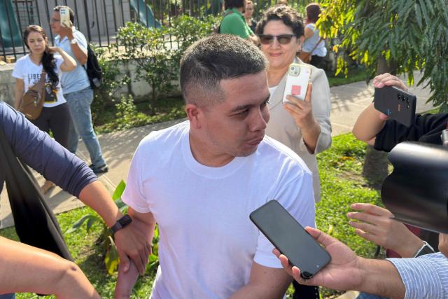 Salvadorian environmental lawyer Alejandro Henriquez speaks with a journalist after a hearing at the Integrated Judicial Center of Santa Tecla, El Salvador on December 17, 2025. El Salvador's judiciary sentenced Salvadorian environmental lawyer Alejandro Henriquez and local leader Jose Angel Perez to three years in prison for "aggressive resistance" and "public disorder", but granted them conditional release, according to the ruling issued on December 17, 2025. They were arrested last May for protesting near the home of President Nayib Bukele. (Photo by Rudy QUIROZ / AFP)