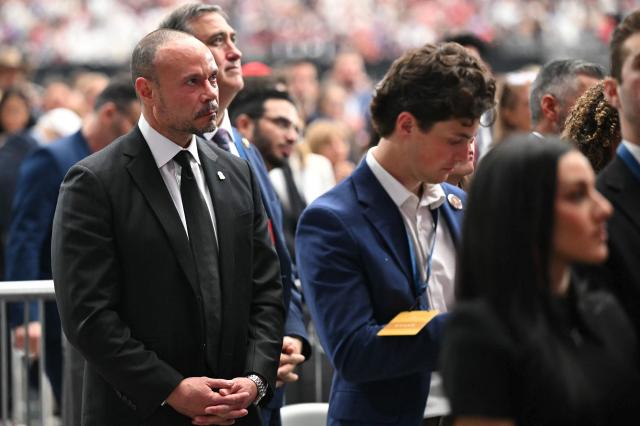 (FILES) FBI Deputy Director Dan Bongino attends the public memorial service for right-wing activist Charlie Kirk at State Farm Stadium in Glendale, Arizona, on September 21, 2025. Bongino, a former right-wing podcaster, announced on December 17, 2025 that he would step down in January after less than 10 months on the job. The 51-year-old Bongino, in a post on X announcing his resignation, did not give a reason for the move. (Photo by Mandel NGAN / AFP)