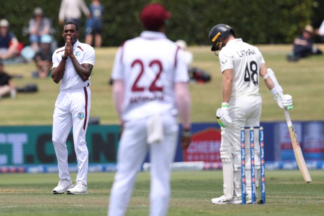 West Indies Justin Greaves (L) looks on after bowling to New Zealand’s Tom Latham (R) during day one of the 3rd international Test cricket match between New Zealand and West Indies at Bay Oval in Mount Maunganui on December 18, 2025. (Photo by Michael Bradley / AFP)
