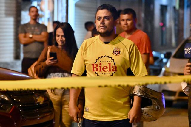 A Barcelona SC fan looks at the site where footballer Mario Pineida was killed in Guayaquil, Ecuador, on December 17, 2025. Ecuadorian footballer Mario Pineida was killed in an attack in the port city of Guayaquil on December 17, 2025, a hotspot for violence in the country due to drug trafficking, according to his club Ecuador's Barcelona. (Photo by MARCOS PIN / AFP)