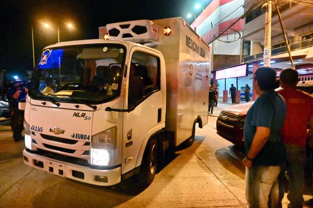 A Forensic Medicine vehicle transports the body of Barcelona SC footballer Mario Pineida after he was killed in Guayaquil, Ecuador, on December 17, 2025. Ecuadorian footballer Mario Pineida was killed in an attack in the port city of Guayaquil on December 17, 2025, a hotspot for violence in the country due to drug trafficking, according to his club Ecuador's Barcelona. (Photo by MARCOS PIN / AFP)