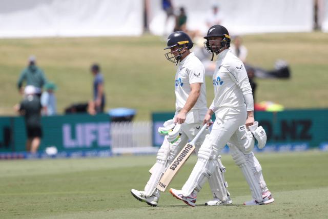New Zealand’s Devon Conway (R) and Tom Latham walk off for lunch during day one of the 3rd international Test cricket match between New Zealand and West Indies at Bay Oval in Mount Maunganui on December 18, 2025. (Photo by Michael Bradley / AFP)