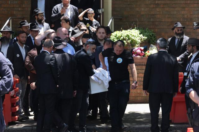 Mourners carry the coffin of 10-year-old Matilda, who was killed in the December 14 Bondi Beach shooting attack, into the hearse after the funeral service in Sydney on December 18, 2025. The attack at Bondi Beach on December 14 was one of the deadliest in Australian history. (Photo by DAVID GRAY / AFP)