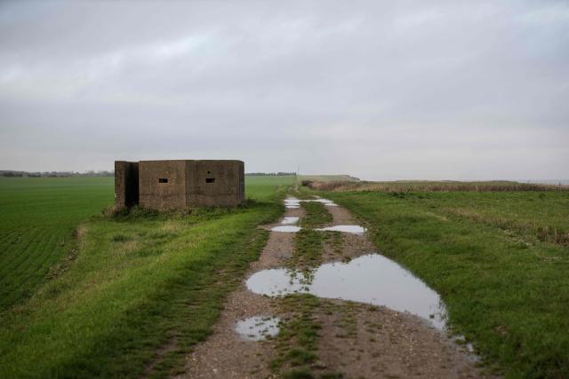 A photograph taken on November 13, 2025 shows the World War military pillbox stands less than 70 meters from the cliff edge, near the village of Atwick, on the North sea coast in an area which is experiencing intense coastal erosion, near Bridlington, in the East Riding of Yorkshire, north eastern England. The Holderness coastline, covering 61km between the Spurn nature reserve in the south and Flamborough in the north, experiences one of the fastest rates of erosion in Europe. The Holderness cliffs are eroding at average rate of around 1.5 metres per year, although individual cliff losses can exceed 20 metres per year. Over the last 1000 years, the coast has retreated by around 2 kilometres, resulting in the destruction of 26 villages listed in the Domesday survey of 1086. (Photo by Oli SCARFF / AFP)