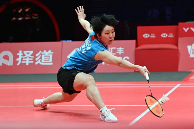 Japan’s Akane Yamaguchi hits a return to Indonesia’s Putri Kusuma Wardani during their women's singles match at the BWF Badminton World Tour Finals at the Hangzhou Olympic Sports Centre Gymnasium in Hangzhou, in eastern China's Zhejiang province on December 18, 2025. (Photo by Jade Gao / AFP)