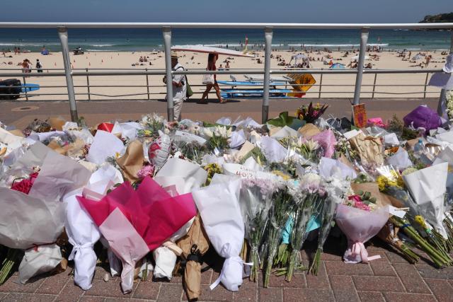 Floral tributes left by mourners are seen at the promenade of Bondi Beach in Sydney on December 18, 2025, to honour victims of the shooting that took place there on December 14. The attack at Bondi Beach on December 14 was one of the deadliest in Australian history. (Photo by DAVID GRAY / AFP)