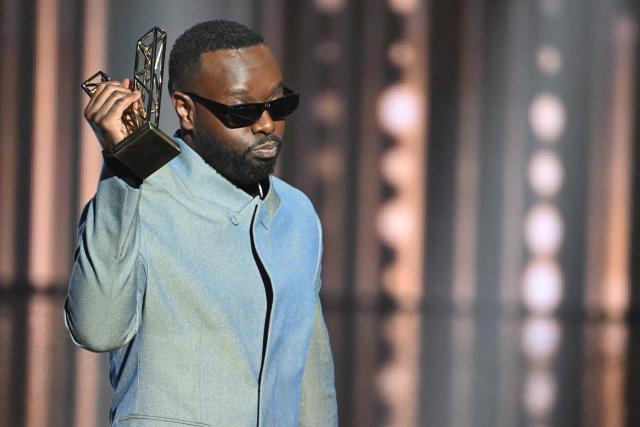 (FILES) Congolese singer Gims celebrates as he receives the Best Male Artist award during the 40th Victoires de la Musique, the annual French music awards ceremony, at the Seine Musicale concert hall in Boulogne-Billancourt, on the outskirts of Paris, on February 14, 2025. Franco-Congolese rapper Gims will perform from December 19 to 22, 2025 at the 45,000-seat Paris La Defense Arena to end his tour. (Photo by Bertrand GUAY / AFP)