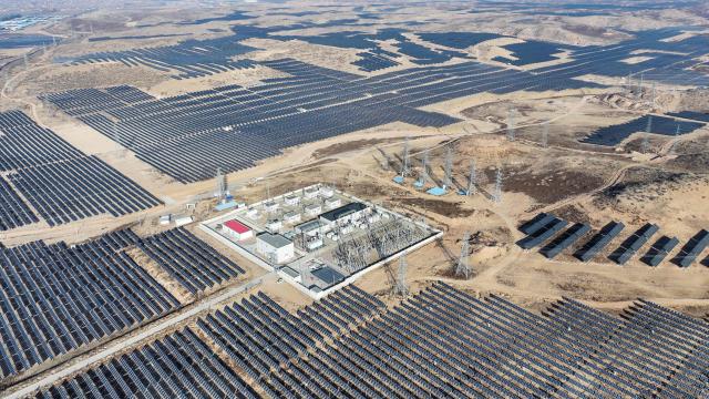 This picture shows an aerial view of solar panels on hilltops at the Yinchuan Fourth Photovoltaic Power Station in Yinchuan, in China’s northern Ningxia region on December 17, 2025. (Photo by AFP) / China OUT