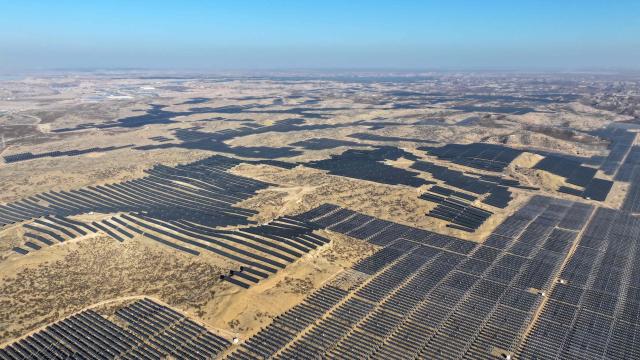 This picture shows an aerial view of solar panels on hilltops at the Yinchuan Fourth Photovoltaic Power Station in Yinchuan, in China’s northern Ningxia region on December 17, 2025. (Photo by AFP) / China OUT