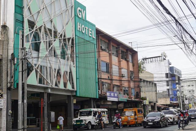 The facade of GV hotel is seen in Davao City, in the Philippines' southern island of Mindanao, where father-and-son duo Sajid and Naveed Akram stayed during their visit in November, weeks before they allegedly killed 15 people on Bondi Beach in Australia. Australian police are investigating whether the pair met with Islamist extremists during a visit to the Philippines weeks before the shooting. (Photo by Ferdinandh CABRERA / AFP)