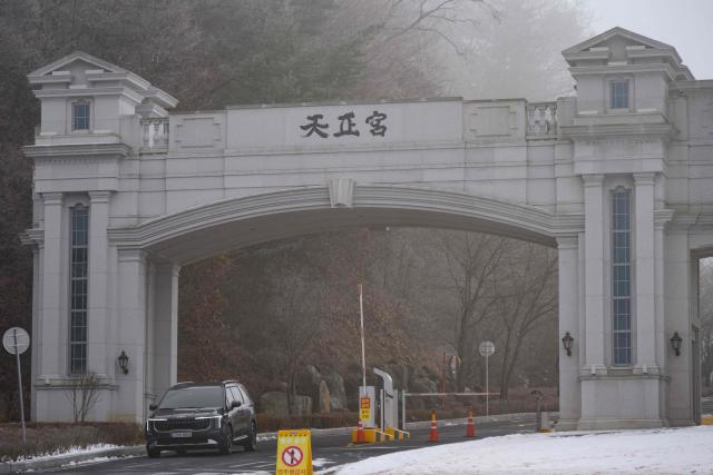 A vehicle leaves the entrance to the Cheon Jeong Gung, the Unification Church leader Han Hak-ja's residence in Gapyeong on December 18, 2025. (Photo by Shin Yong-ju / AFP)