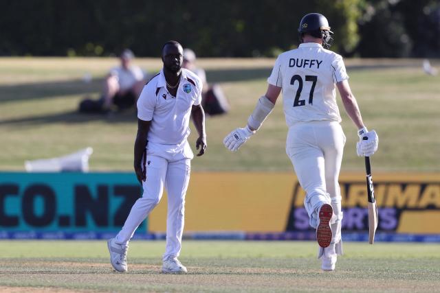 West Indies' Kemar Roach reaches for his hamstring after bowling his last ball of the day during day one of the 3rd international Test cricket match between New Zealand and West Indies at Bay Ovali in Mount Maunganui on December 18, 2025. (Photo by Michael Bradley / AFP)