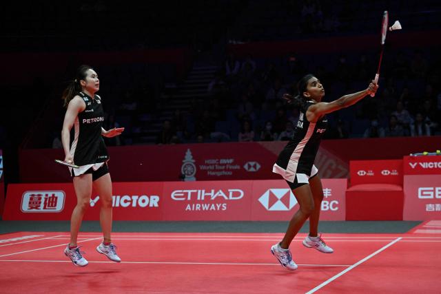 Malaysia’s Pearly Tan and Thinaah Muralitharan (R) play a point during their women's doubles match against Japan’s Rin Iwanaga and Kie Nakanishi at the BWF Badminton World Tour Finals at the Hangzhou Olympic Sports Centre Gymnasium in Hangzhou, in eastern China's Zhejiang province on December 18, 2025. (Photo by Jade Gao / AFP)