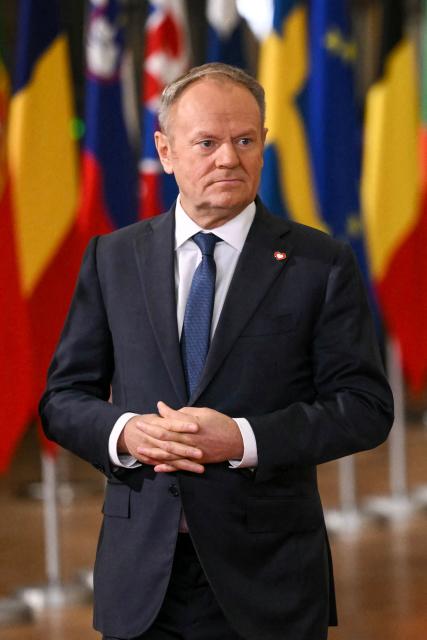 Poland's Prime Minister Donald Tusk looks on as he arrives to attend the European Council meeting in Brussels on December 18, 2025. European Unions leaders meet in Brussels on December 18 and 19, 2025, to discuss in particular the need to support Ukraine, transatlantic relations and the EU's strategic autonomy. (Photo by NICOLAS TUCAT / AFP)
