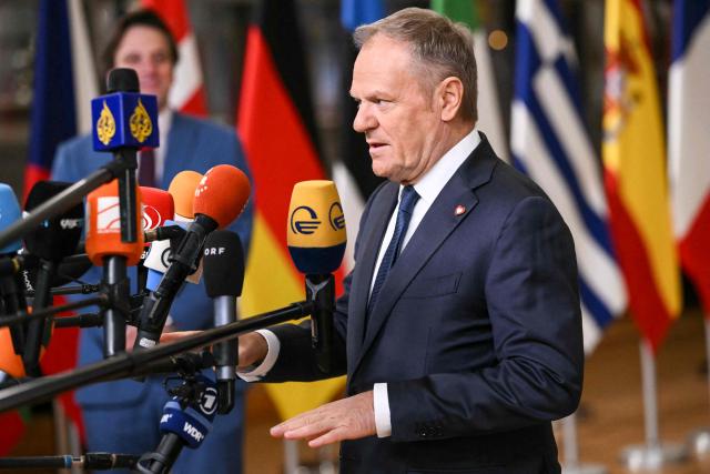 Poland's Prime Minister Donald Tusk speaks to the press as he arrives to attend the European Council meeting in Brussels on December 18, 2025. European Unions leaders meet in Brussels on December 18 and 19, 2025, to discuss in particular the need to support Ukraine, transatlantic relations and the EU's strategic autonomy. (Photo by NICOLAS TUCAT / AFP)