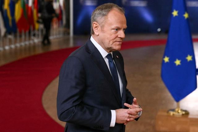 Poland's Prime Minister Donald Tusk looks on as he arrives to attend the European Council meeting in Brussels on December 18, 2025. European Unions leaders meet in Brussels on December 18 and 19, 2025, to discuss in particular the need to support Ukraine, transatlantic relations and the EU's strategic autonomy. (Photo by NICOLAS TUCAT / AFP)