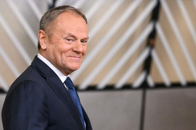 Poland's Prime Minister Donald Tusk looks on as he arrives to attend the European Council meeting in Brussels on December 18, 2025. European Unions leaders meet in Brussels on December 18 and 19, 2025, to discuss in particular the need to support Ukraine, transatlantic relations and the EU's strategic autonomy. (Photo by NICOLAS TUCAT / AFP)
