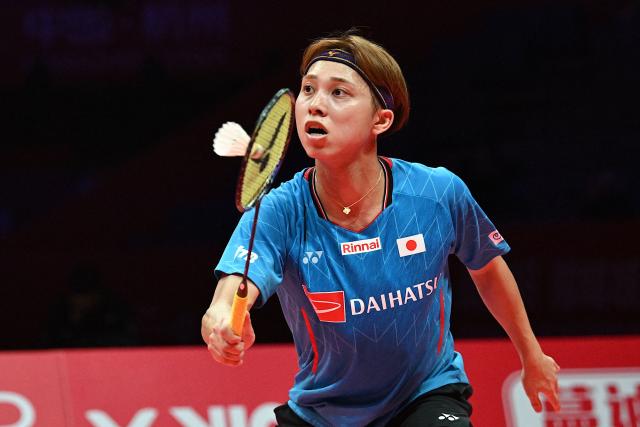 Japan’s Kodai Naraoka hits a return to China’s Li Shifeng during their men's singles match at the BWF Badminton World Tour Finals at the Hangzhou Olympic Sports Centre Gymnasium in Hangzhou, in eastern China's Zhejiang province on December 18, 2025. (Photo by Jade Gao / AFP)