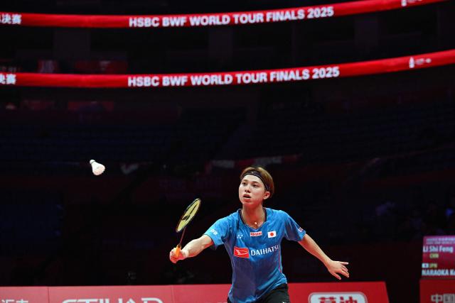 Japan’s Kodai Naraoka hits a return to China’s Li Shifeng during their men's singles match at the BWF Badminton World Tour Finals at the Hangzhou Olympic Sports Centre Gymnasium in Hangzhou, in eastern China's Zhejiang province on December 18, 2025. (Photo by Jade Gao / AFP)