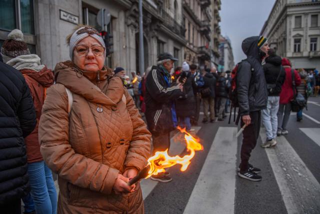 (FILES) Protesters are seen on the streets during a demonstration where they demand Hungary's Prime Minister's resignation over the government's perceived inaction about widespread abuse in child care institutions in Budapest, Hungary, on December 13, 2025. With four months to go until key Hungarian elections, mounting public outrage over perceived inaction on child abuse allegations in state-run institutions is shrinking Prime Minister Viktor Orban's chances to hold onto power. That scandal has shaken the nationalist leader's tight grip on power and helped fuel the rise of Hungarian opposition leader Peter Magyar, a former government insider. (Photo by Ferenc ISZA / AFP)
