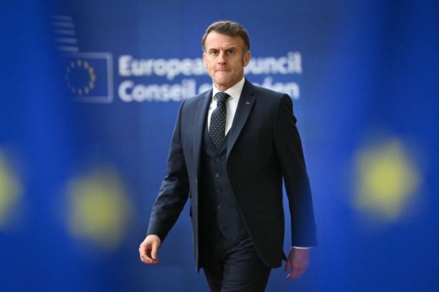 France's President Emmanuel Macron reacts as he arrives to attend the European Council meeting in Brussels on December 18, 2025. European Unions leaders meet in Brussels on December 18 and 19, 2025, to discuss in particular the need to support Ukraine, transatlantic relations and the EU's strategic autonomy. (Photo by NICOLAS TUCAT / AFP)