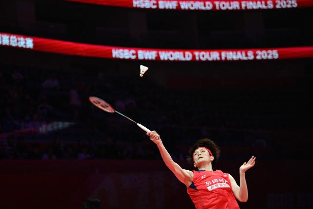 China’s Wang Zhiyi hits a return to Thailand’s Ratchanok Intanon during their women’s singles match at the BWF Badminton World Tour Finals at the Hangzhou Olympic Sports Centre Gymnasium in Hangzhou, in eastern China's Zhejiang province on December 18, 2025. (Photo by Jade Gao / AFP)