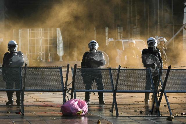Police officers stand in front of the European Parliament, during a farmers' protest to denounce the reforms of the Common Agricultural Policy (CAP) and trade agreements such as the Mercosur, in Brussels, on December 18, 2025, organised by Copa-Cogeca, the main association representing farmers and agricultural cooperatives in the EU. EU Farmers, particularly in France, worry the Mercosur deal -- which will be discussed at the EU leaders meeting -- will see them undercut by a flow of cheaper goods from agricultural giant Brazil and its neighbours. They also oppose plans put forward by the European Commission to overhaul the 27-nation bloc's huge farming subsidies, fearing less money will flow their way. (Photo by NICOLAS TUCAT / AFP)