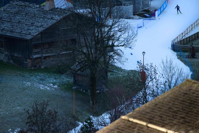 A skier pratices on a slope lacking snow during the IBU Biathlon World Cup in Le Grand Bornand near Annecy, central-eastern France, on December 18, 2025. (Photo by OLIVIER CHASSIGNOLE / AFP)