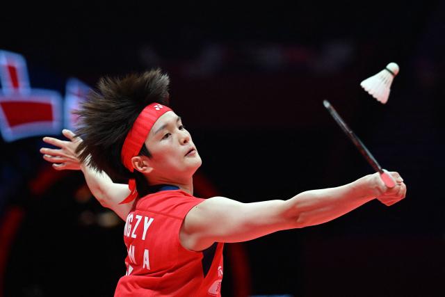 China’s Wang Zhiyi hits a return to Thailand’s Ratchanok Intanon during their women’s singles match at the BWF Badminton World Tour Finals at the Hangzhou Olympic Sports Centre Gymnasium in Hangzhou, in eastern China's Zhejiang province on December 18, 2025. (Photo by Jade Gao / AFP)