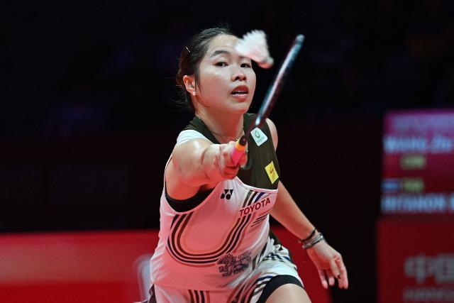 Thailand’s Ratchanok Intanon hits a return to China’s Wang Zhiyi during their women’s singles match at the BWF Badminton World Tour Finals at the Hangzhou Olympic Sports Centre Gymnasium in Hangzhou, in eastern China's Zhejiang province on December 18, 2025. (Photo by Jade Gao / AFP)