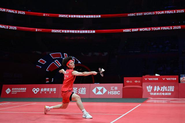 China’s Wang Zhiyi hits a return to Thailand’s Ratchanok Intanon during their women’s singles match at the BWF Badminton World Tour Finals at the Hangzhou Olympic Sports Centre Gymnasium in Hangzhou, in eastern China's Zhejiang province on December 18, 2025. (Photo by Jade Gao / AFP)