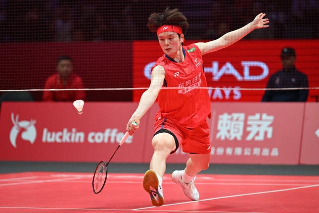 China’s Wang Zhiyi hits a return to Thailand’s Ratchanok Intanon during their women’s singles match at the BWF Badminton World Tour Finals at the Hangzhou Olympic Sports Centre Gymnasium in Hangzhou, in eastern China's Zhejiang province on December 18, 2025. (Photo by Jade Gao / AFP)