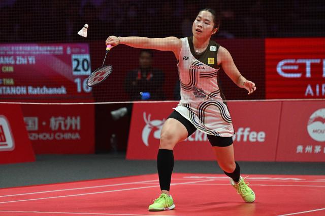 Thailand’s Ratchanok Intanon hits a return to China’s Wang Zhiyi during their women’s singles match at the BWF Badminton World Tour Finals at the Hangzhou Olympic Sports Centre Gymnasium in Hangzhou, in eastern China's Zhejiang province on December 18, 2025. (Photo by Jade Gao / AFP)