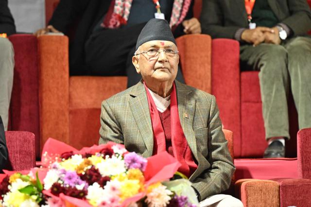 Former Nepali Prime Minister and newly elected leader of the Communist Party of Nepal - Unified Marxist Leninist (CPN-UML), KP Sharma Oli looks on during the party's 11th general convention in Kathmandu on December 18, 2025. Members of ousted Nepali prime minister KP Sharma Oli's political party voted for him to retain leadership of the organisation on December 18, meaning he will oversee its preparations for national elections next year. (Photo by PRAKASH MATHEMA / AFP)