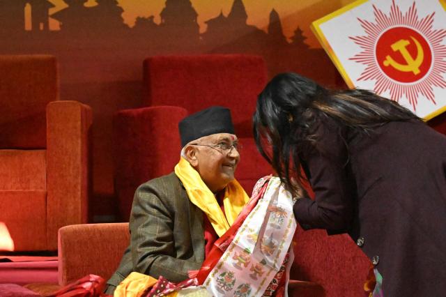 Former Nepali Prime Minister and newly elected leader of the Communist Party of Nepal - Unified Marxist Leninist (CPN-UML), KP Sharma Oli is congratulated by supporters during the party's 11th general convention in Kathmandu on December 18, 2025. Members of ousted Nepali prime minister KP Sharma Oli's political party voted for him to retain leadership of the organisation on December 18, meaning he will oversee its preparations for national elections next year. (Photo by PRAKASH MATHEMA / AFP)