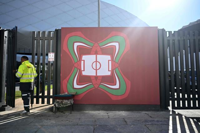 An employees enters the Al-Medina Stadium in Rabat, on December 18, 2025, ahead of the Africa Cup of Nations (AFCON). The competition begins on December 21. (Photo by Paul ELLIS / AFP)