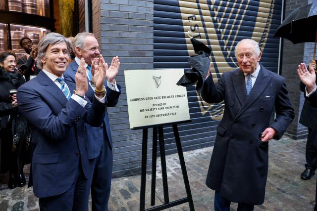King Charles III (R) unveils a plaque to mark the official opening of the Brewery, next to Nik Jhangiani, Interim Chief Executive Officer of Diageo plc and John Manzoni, Chair of Diageo plc during his visit to Guinness Open Gate Brewery London on December 18, 2025. The Guinness Open Gate Brewery, a £73 million investment, contains a microbrewery, visitor experience, restaurants, shops, and events space, and will serve as the UK southern hub for Diageos award-winning Learning for Life programme. (Photo by Chris Jackson / POOL / AFP)